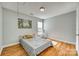 Cozy bedroom featuring a double bed and a window at 1309 Winding Branch Ct, Charlotte, NC 28216