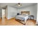 Well-lit bedroom with wood flooring and ceiling fan at 1309 Winding Branch Ct, Charlotte, NC 28216