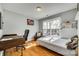 Bedroom with a home office setup and large window at 1309 Winding Branch Ct, Charlotte, NC 28216