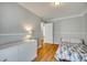 Well-lit bedroom featuring wood floors and ample space at 1309 Winding Branch Ct, Charlotte, NC 28216