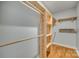 Spacious closet with wood shelving and hanging rods at 1309 Winding Branch Ct, Charlotte, NC 28216