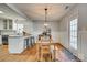 Bright dining area with wooden table, bench, and access to kitchen at 1309 Winding Branch Ct, Charlotte, NC 28216