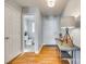 Light and airy entryway with hardwood floors, half-bathroom, and console table at 1309 Winding Branch Ct, Charlotte, NC 28216