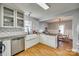 Bright kitchen features granite counters, farmhouse sink, and eat-in area at 1309 Winding Branch Ct, Charlotte, NC 28216