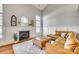 Living room with fireplace, L-shaped sofa, and hardwood floors at 1309 Winding Branch Ct, Charlotte, NC 28216