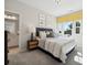 Bedroom with striped bedding and en-suite bathroom at 1482 Hubert Graham Way, Tega Cay, SC 29708