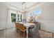 Formal dining room featuring hardwood floors, wainscoting, and a chandelier at 1482 Hubert Graham Way, Tega Cay, SC 29708