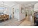 Bright dining room with hardwood floors and elegant light fixture at 1482 Hubert Graham Way, Tega Cay, SC 29708