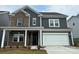 Two-story home with brick and gray siding, white trim, and a two-car garage at 1482 Hubert Graham Way, Tega Cay, SC 29708