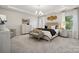 Elegant main bedroom with plush bedding and a chandelier at 1482 Hubert Graham Way, Tega Cay, SC 29708