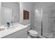 Clean bathroom with white vanity, large mirror and a walk-in shower at 15306 Ballancroft Pkwy # 21, Charlotte, NC 28277