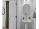 Simple bathroom with pedestal sink and round mirror at 15310 Ballancroft Pkwy # 20, Charlotte, NC 28277