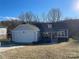 House exterior with a gray siding, attached garage, and landscaping at 1544 Farmington Hills Dr, Conover, NC 28613