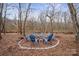 Stone fire pit with chairs in wooded area at 1544 Farmington Hills Dr, Conover, NC 28613