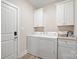 Convenient laundry room with washer, dryer, and ample storage at 1544 Farmington Hills Dr, Conover, NC 28613