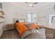 Main bedroom with orange comforter and sitting area at 1544 Farmington Hills Dr, Conover, NC 28613