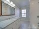 Bright bathroom with marble vanity, subway tile, and window at 156 Elrosa Rd, Mooresville, NC 28115