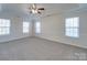 Bright bedroom featuring neutral carpet and multiple windows at 156 Elrosa Rd, Mooresville, NC 28115