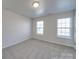 Bedroom featuring gray carpet and two large windows at 156 Elrosa Rd, Mooresville, NC 28115