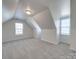 Bedroom with gray carpet, sloped ceilings, and two windows at 156 Elrosa Rd, Mooresville, NC 28115