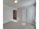 Bedroom with gray carpet, door to hallway, and double closet at 156 Elrosa Rd, Mooresville, NC 28115