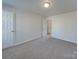 Bedroom with gray carpet, door to bathroom, and closet at 156 Elrosa Rd, Mooresville, NC 28115