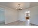 Bright dining room features chandelier, wood-look floors, and view into kitchen at 156 Elrosa Rd, Mooresville, NC 28115