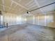 Unfinished garage with concrete floor and door at 156 Elrosa Rd, Mooresville, NC 28115