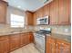 Updated kitchen with stainless steel appliances and tile backsplash at 156 Elrosa Rd, Mooresville, NC 28115