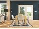 Dining area with a wooden table, white chairs, and a navy blue wall at 1602 Croyden St, Indian Land, SC 29707