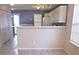 Kitchen with breakfast bar, white cabinets and a view into the dining area at 16740 Timber Crossing Rd, Charlotte, NC 28213