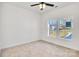 Well-lit bedroom featuring neutral carpeting, large windows, and ceiling fan at 1715 Pope Ave, Gastonia, NC 28052