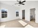 Bright bedroom with neutral carpeting, ceiling fan, and ample natural light at 1715 Pope Ave, Gastonia, NC 28052