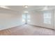 Well-lit bedroom featuring carpet and multiple windows at 2125 Clifton Rd, Sherrills Ford, NC 28673