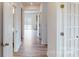 Light and bright hallway with light wood flooring and access to other rooms at 2125 Clifton Rd, Sherrills Ford, NC 28673