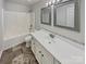 Bathroom featuring a bathtub, vanity with a white countertop and grey framed mirror at 2154 Pheasant Glen Rd, Charlotte, NC 28214