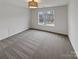 Bedroom with grey carpet, a window, and a ceiling light at 2154 Pheasant Glen Rd, Charlotte, NC 28214