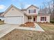 Two-story house with attached garage and landscaped front yard at 2154 Pheasant Glen Rd, Charlotte, NC 28214