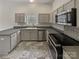 Modern kitchen with stainless steel appliances and grey cabinets at 2154 Pheasant Glen Rd, Charlotte, NC 28214