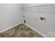 Laundry room with tile flooring and overhead shelving at 2154 Pheasant Glen Rd, Charlotte, NC 28214