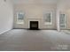 Spacious living room with a fireplace and neutral carpeting at 2154 Pheasant Glen Rd, Charlotte, NC 28214