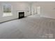 Spacious living room featuring a fireplace and grey carpeting at 2154 Pheasant Glen Rd, Charlotte, NC 28214