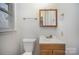 Simple bathroom with wood vanity and updated fixtures at 2214 Munsen Rd, Concord, NC 28025