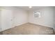 Well-lit bedroom with neutral walls and carpeted floors at 2214 Munsen Rd, Concord, NC 28025