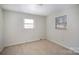 Well-lit bedroom featuring neutral walls and carpeted floors at 2214 Munsen Rd, Concord, NC 28025