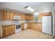 Bright kitchen featuring wood cabinets, granite countertops, and modern appliances at 2214 Munsen Rd, Concord, NC 28025