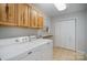 Laundry room with washer, dryer, cabinets, and built-in shelving at 2214 Munsen Rd, Concord, NC 28025