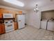 Kitchen with wood cabinets, white appliances, and tile floor at 2240 15Th Ne Ave # 105, Hickory, NC 28601