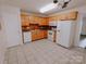 Kitchen with wood cabinets, white appliances, and tile floor at 2240 15Th Ne Ave # 105, Hickory, NC 28601