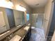 Bathroom with double vanity and a glass-enclosed shower at 22433 Gateway Dr, Lancaster, SC 29720